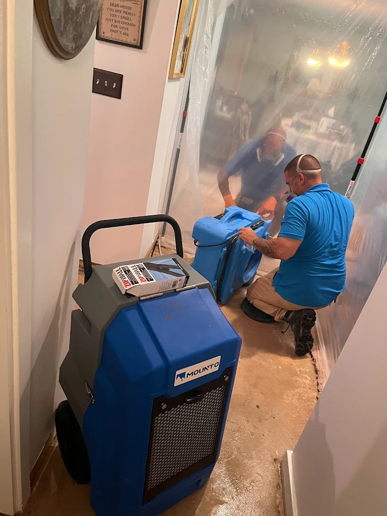 Technicians setting up drying equipment after water damage